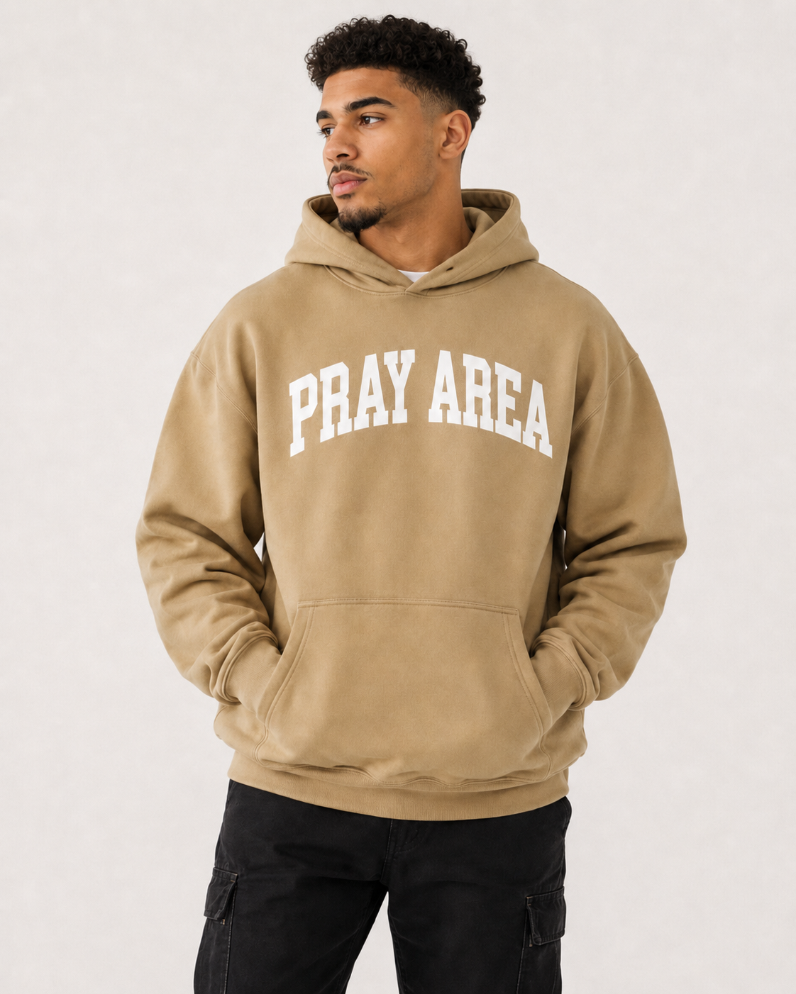 Male model wearing the tan Pray Area heavyweight Christian hoodie by Gospel Swag