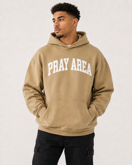Male model wearing the tan Pray Area heavyweight Christian hoodie by Gospel Swag